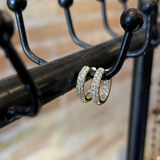 Photo of Mini Inside-Out Diamond Hoops in a decorative scene, designed by , available at Plumb Gold & Plumb Silver