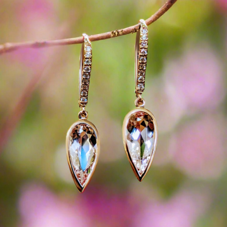 Photo of Morganite Bezel Dangle Earrings in a decorative scene, designed by -, available at Plumb Gold & Plumb Silver