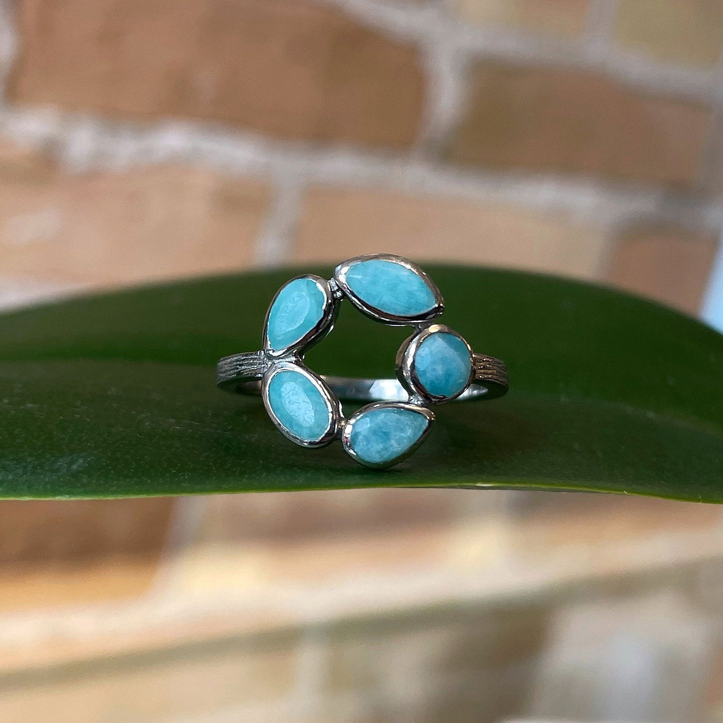 Photo of “Morning” Ring in a decorative scene, designed by , available at Plumb Gold & Plumb Silver