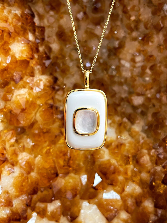 Photo of Mother of Pearl Pendant in a decorative scene, designed by , available at Plumb Gold & Plumb Silver