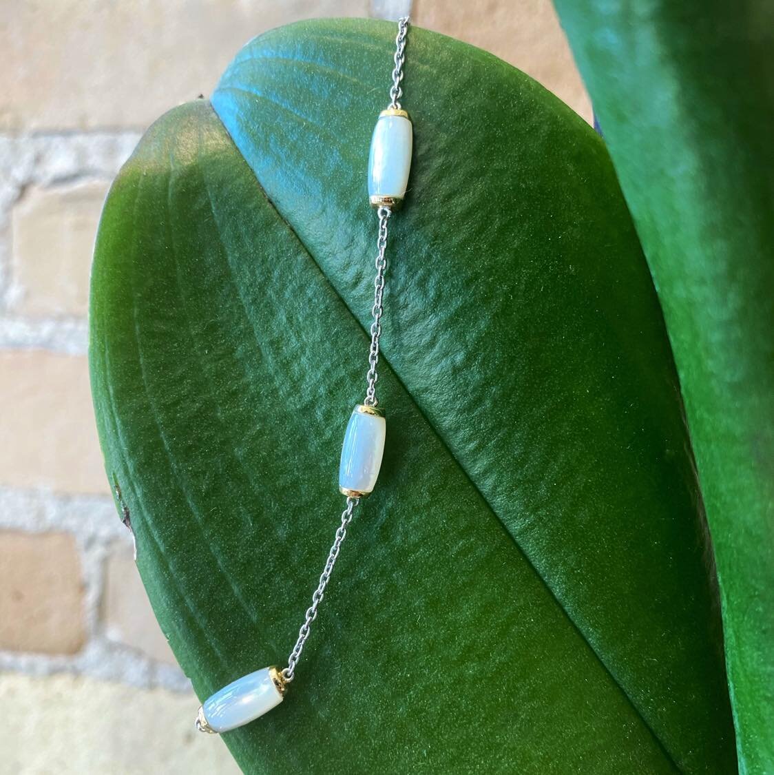 Photo of Mother of Pearl Station Bracelet in a decorative scene, designed by , available at Plumb Gold & Plumb Silver