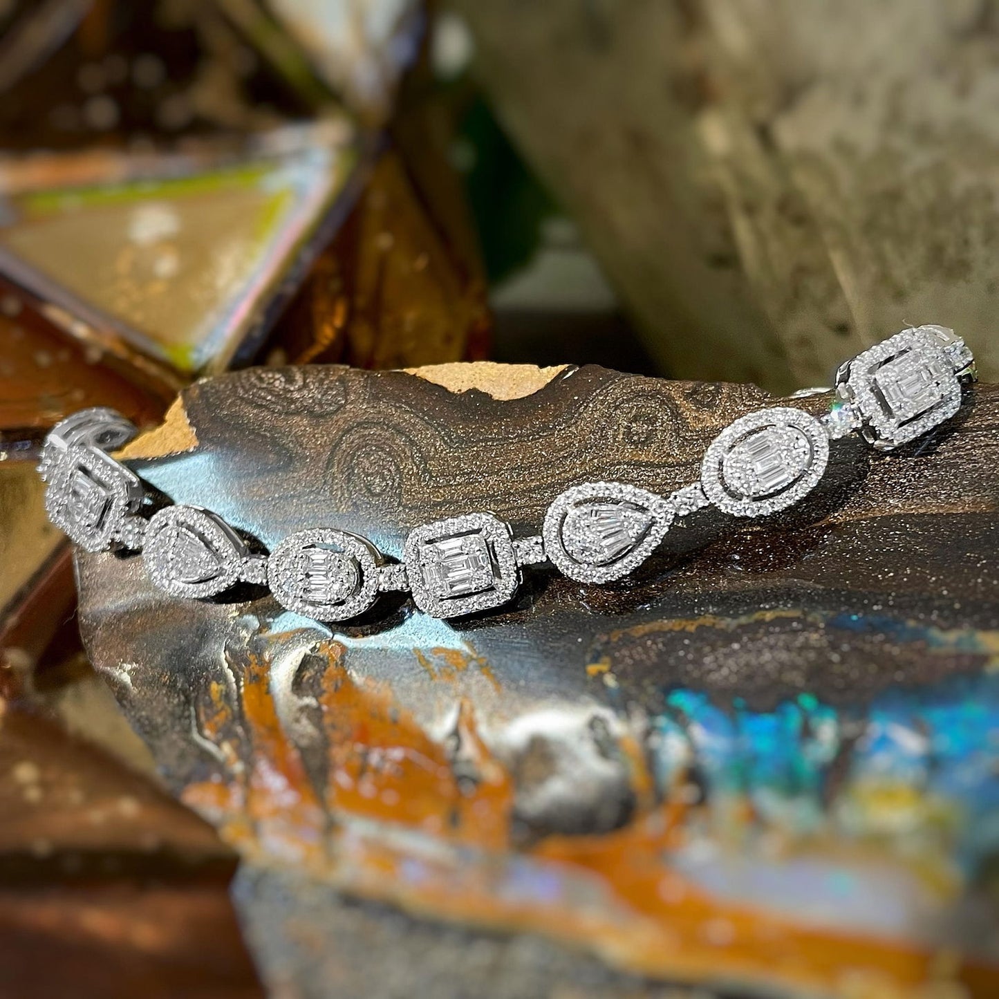 Photo of Multi-Shape Diamond Bracelet in a decorative scene, designed by , available at Plumb Gold & Plumb Silver