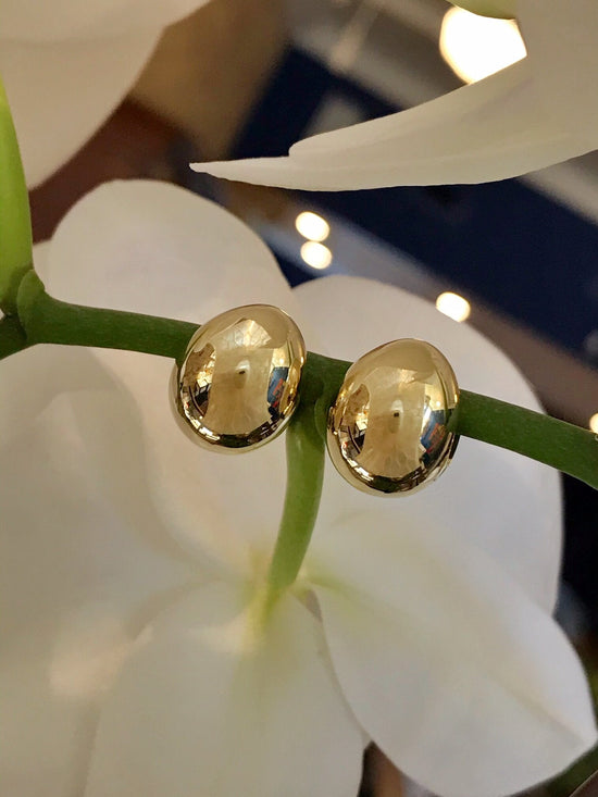 Photo of Oblong Globe Huggies in a decorative scene, designed by , available at Plumb Gold & Plumb Silver