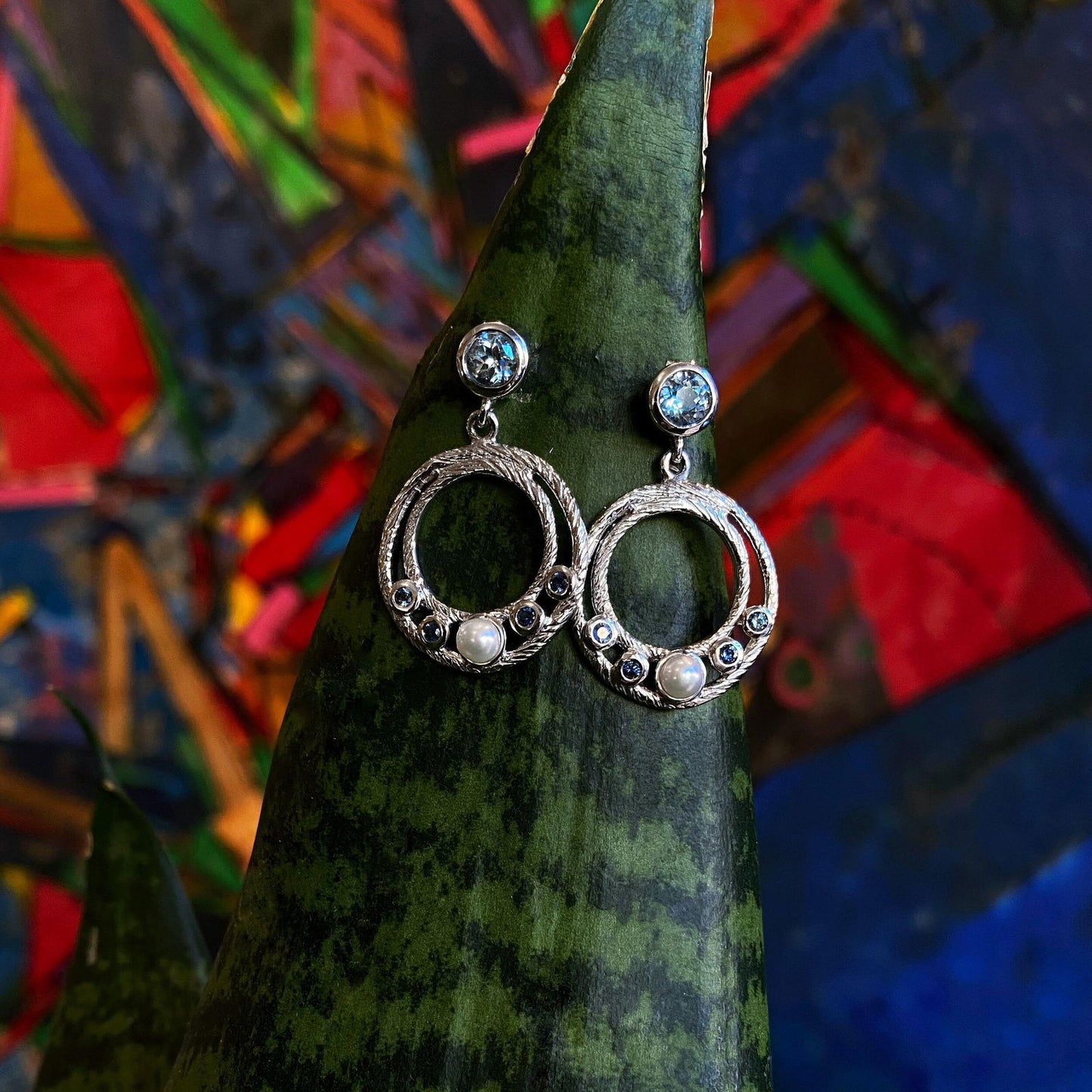 Photo of Ocean Dangle Earrings in a decorative scene, designed by , available at Plumb Gold & Plumb Silver