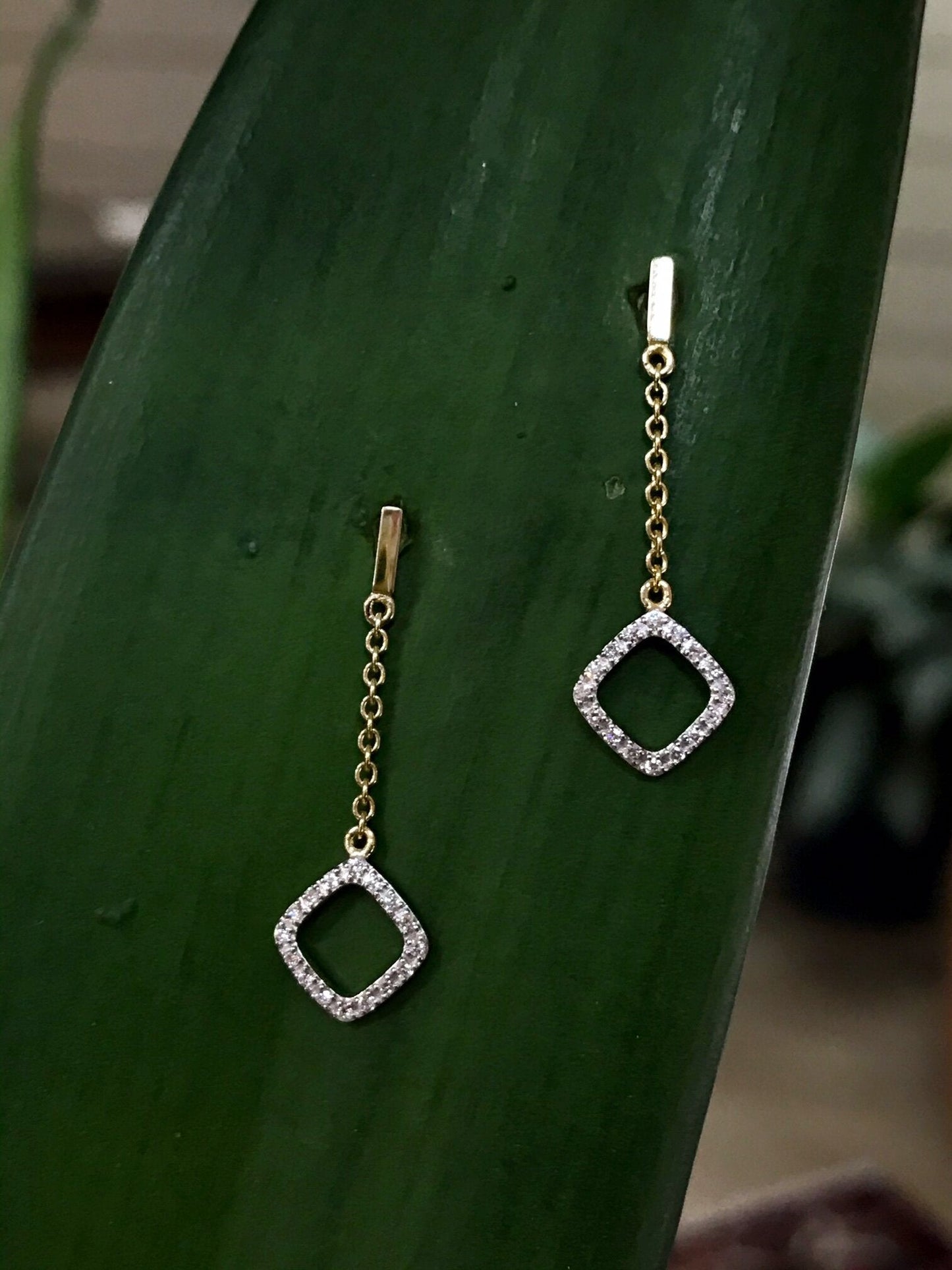 Photo of Open Diamond Dangles in a decorative scene, designed by , available at Plumb Gold & Plumb Silver