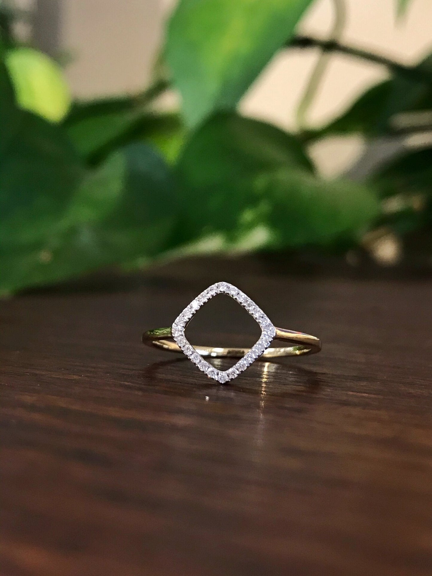 Photo of Open Diamond Ring in a decorative scene, designed by , available at Plumb Gold & Plumb Silver