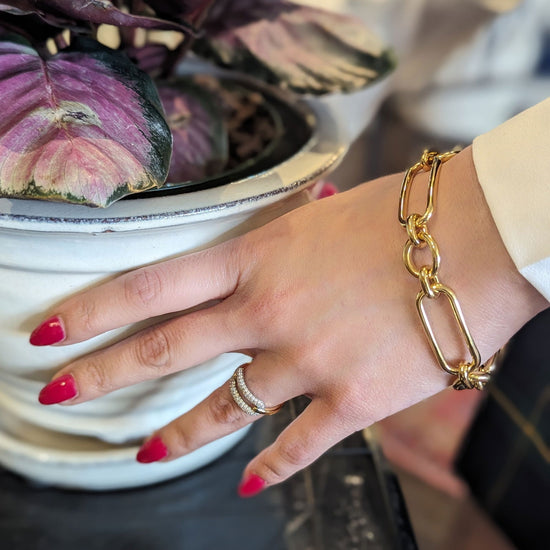 Photo of Open Link Bracelet in a decorative scene, designed by , available at Plumb Gold & Plumb Silver