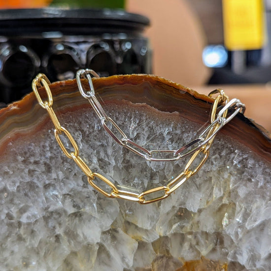 Photo of Paperclip Bracelet in a decorative scene, designed by , available at Plumb Gold & Plumb Silver