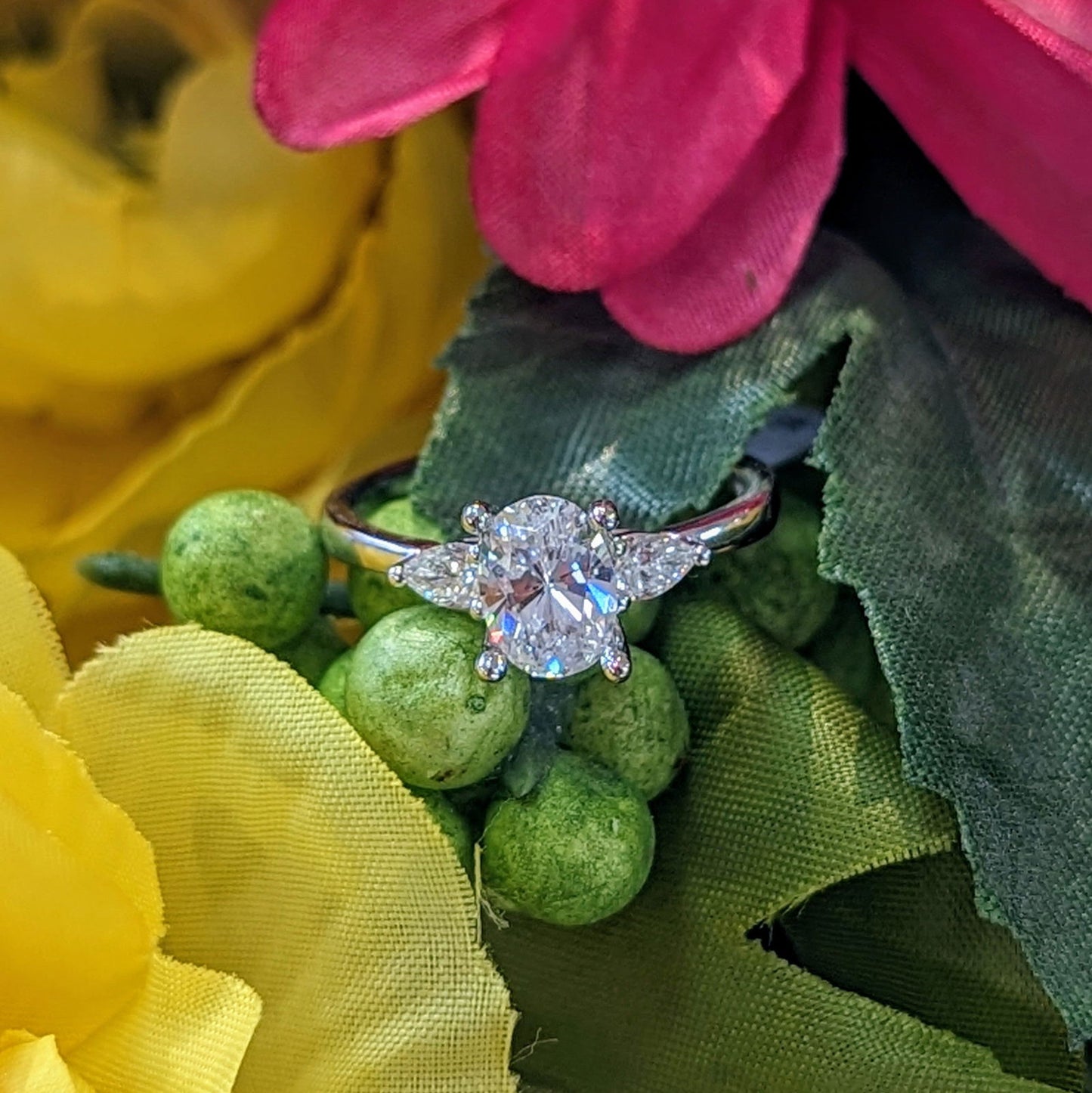 Photo of Pear Accented Engagement Ring Mounting in a decorative scene, designed by , available at Plumb Gold & Plumb Silver