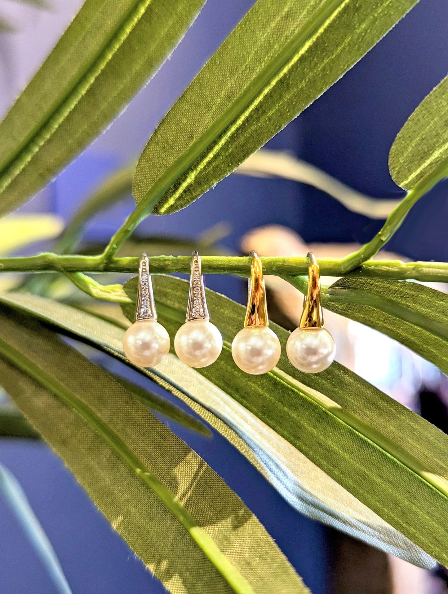 Photo of Pearl Drop Earrings in a decorative scene, designed by , available at Plumb Gold & Plumb Silver