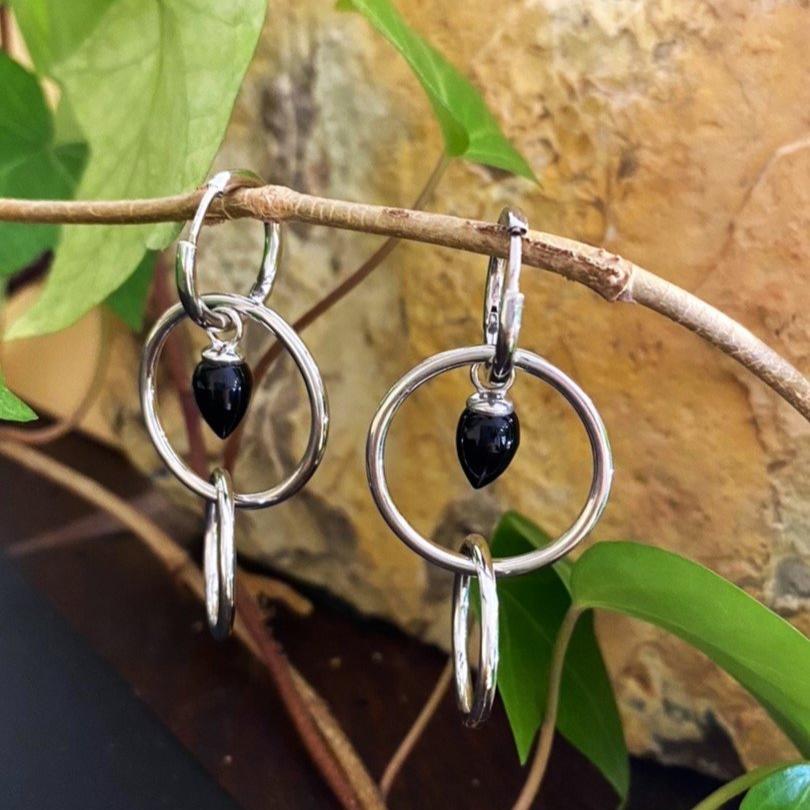 Photo of Pendulum Earring in a decorative scene, designed by -, available at Plumb Gold & Plumb Silver