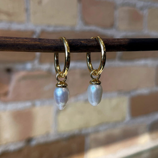 Photo of “Pendulum” Pearl Dangles in a decorative scene, designed by , available at Plumb Gold & Plumb Silver
