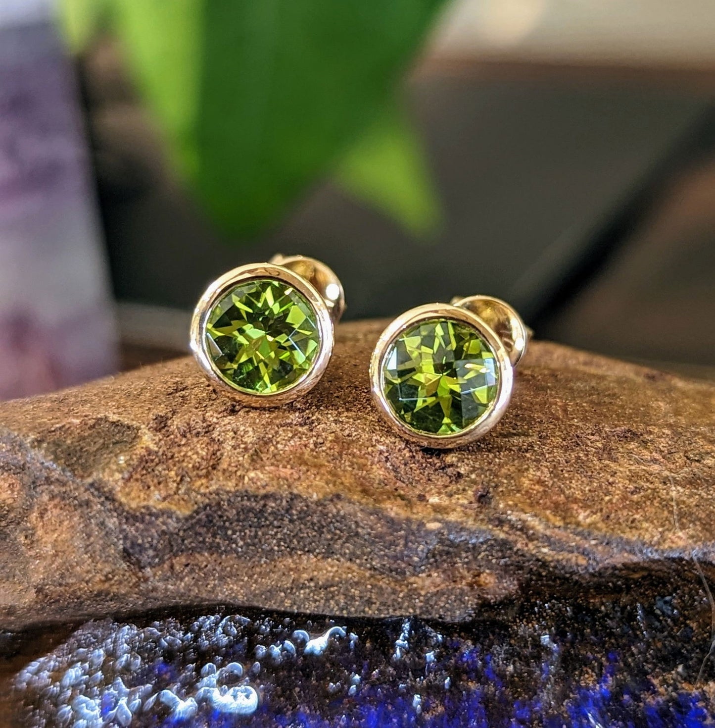 Photo of Peridot Bezel Studs in a decorative scene, designed by , available at Plumb Gold & Plumb Silver
