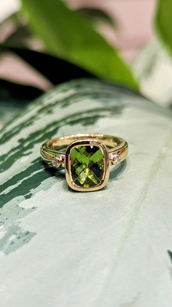 Photo of Peridot Ring in a decorative scene, designed by , available at Plumb Gold & Plumb Silver