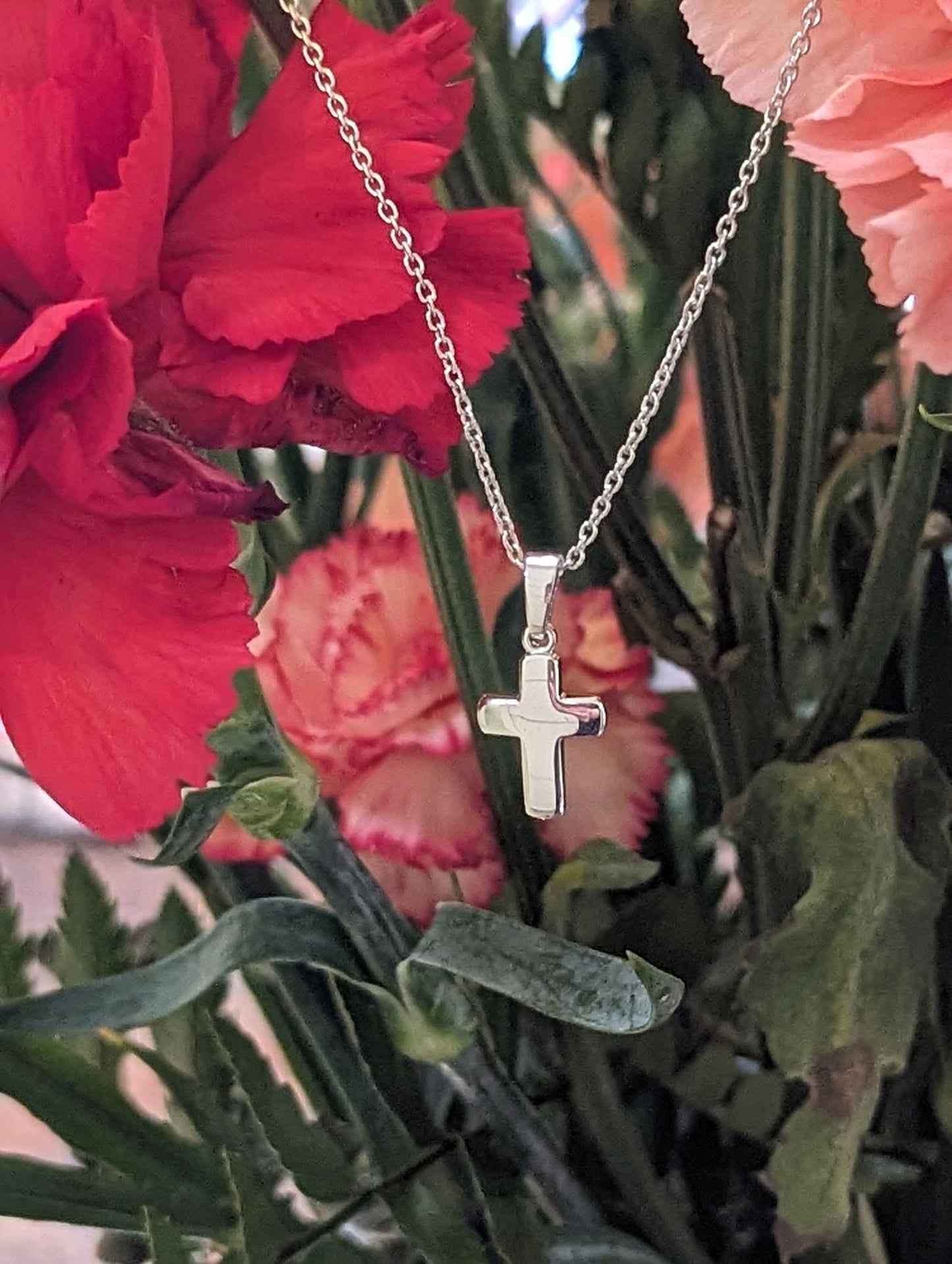 Photo of Petite Simple Cross in a decorative scene, designed by , available at Plumb Gold & Plumb Silver