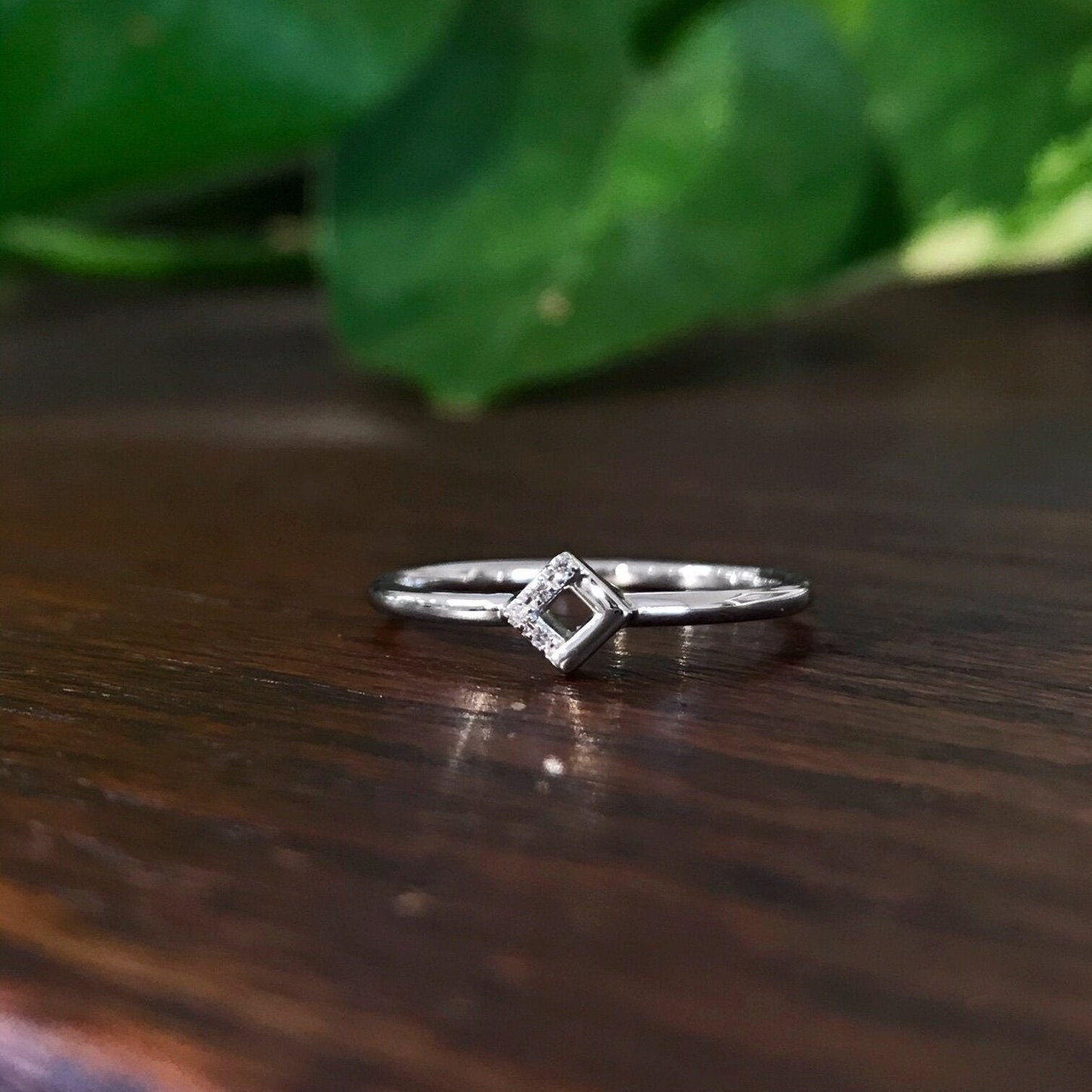 Photo of Petite Square Ring in a decorative scene, designed by , available at Plumb Gold & Plumb Silver