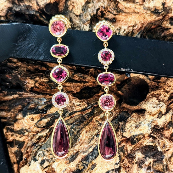 Photo of Pink Muti-Gem Dangle Earrings in a decorative scene, designed by , available at Plumb Gold & Plumb Silver