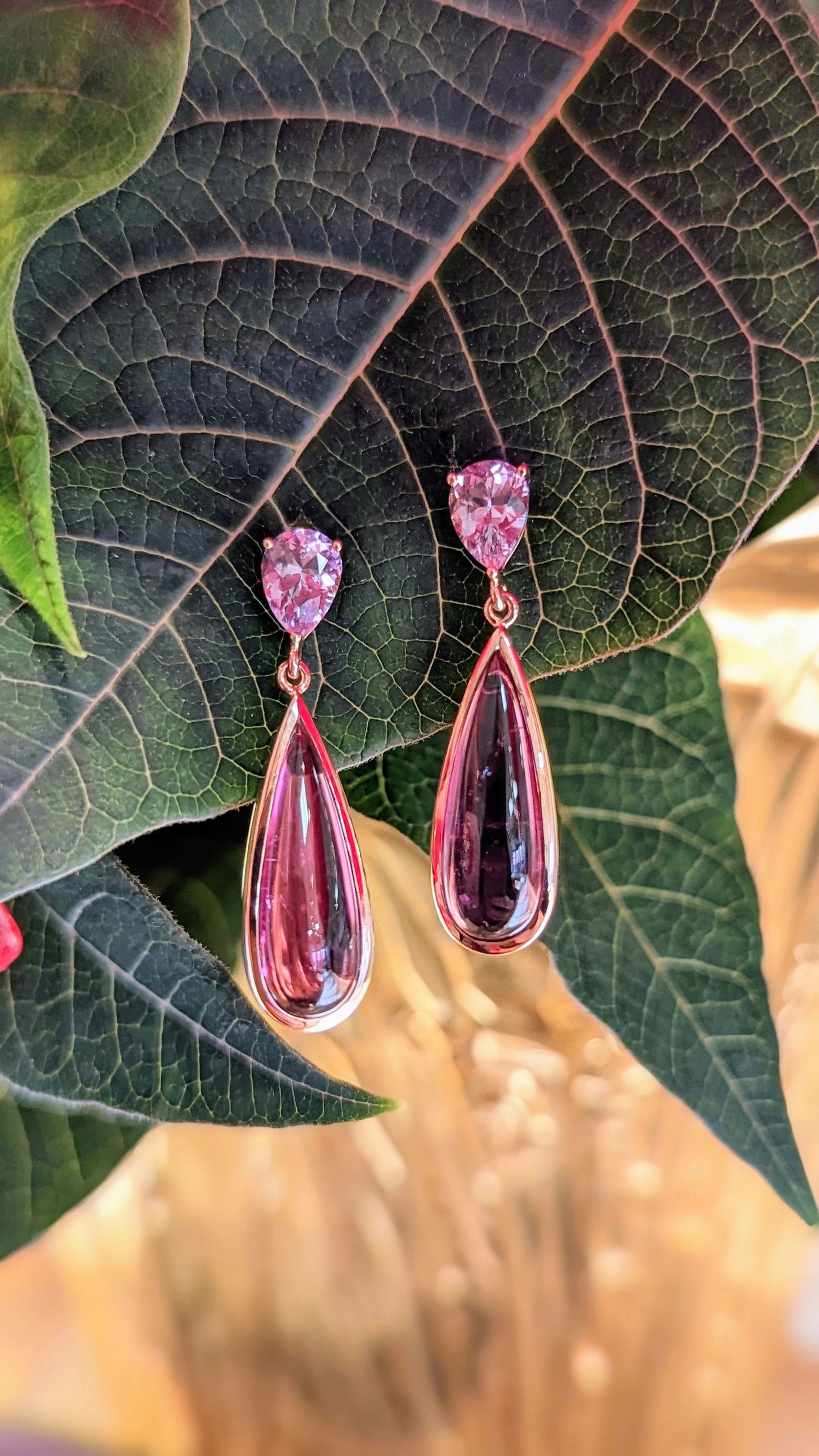 Photo of Pink Tourmaline Drop earrings in a decorative scene, designed by , available at Plumb Gold & Plumb Silver