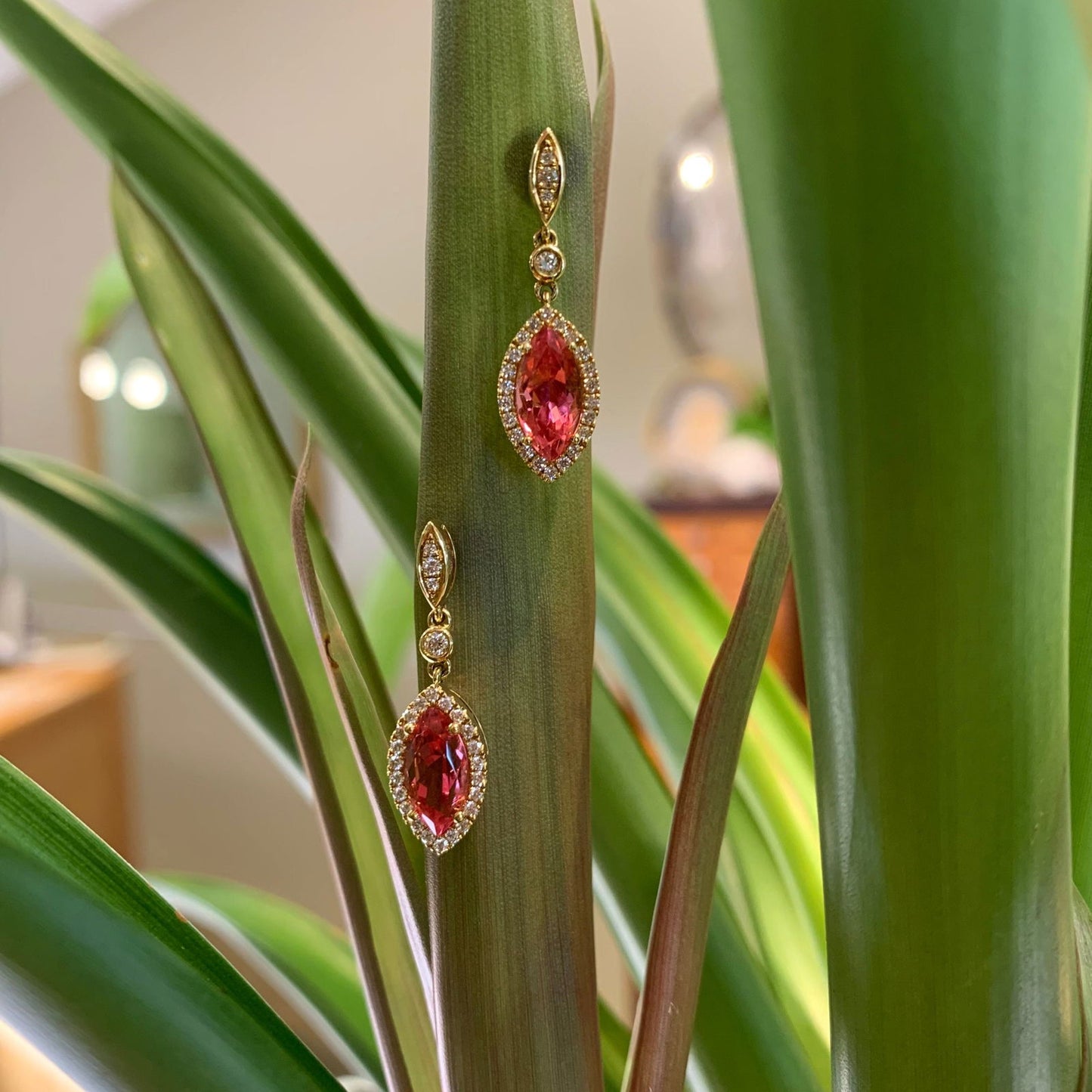 Photo of Pink Tourmaline Marquise Dangle Earrings in a decorative scene, designed by , available at Plumb Gold & Plumb Silver