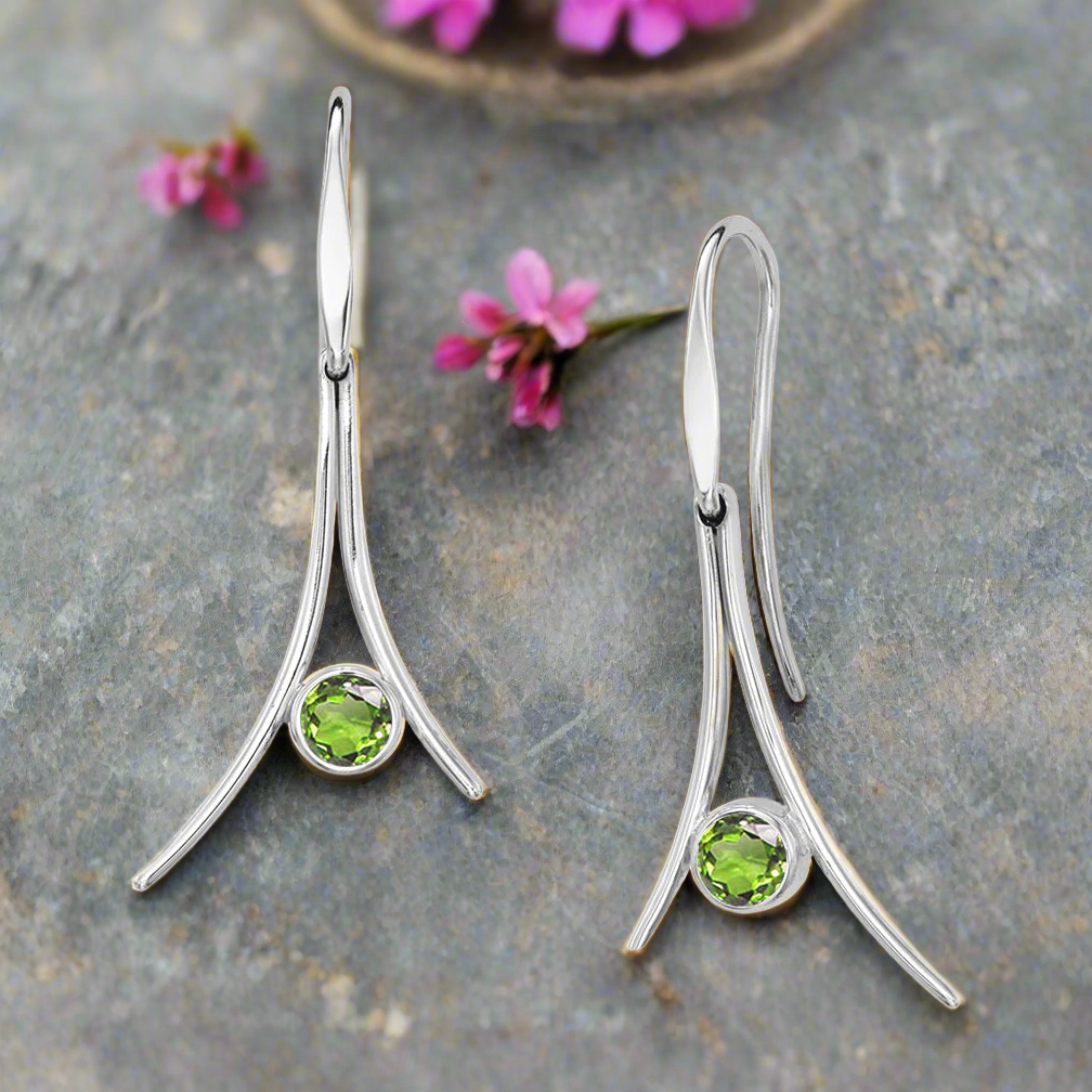 Photo of "Pinnacle" Dangle Earrings in a decorative scene, designed by , available at Plumb Gold & Plumb Silver