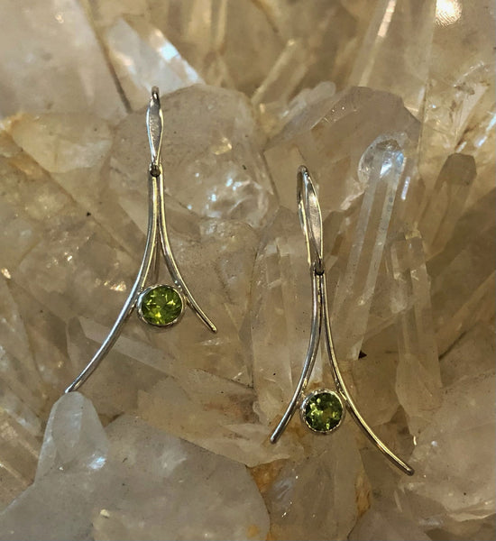 Photo of "Pinnacle" Dangle Earrings in a decorative scene, designed by , available at Plumb Gold & Plumb Silver