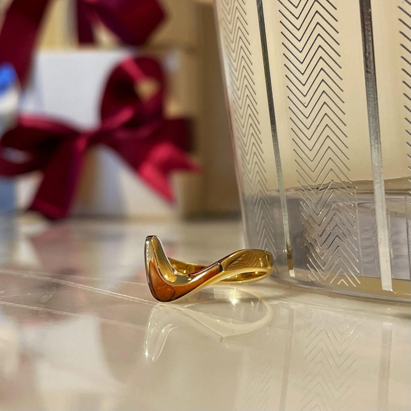 Photo of Plumb Gold Legacy Swoop Ring in a decorative scene, designed by , available at Plumb Gold & Plumb Silver