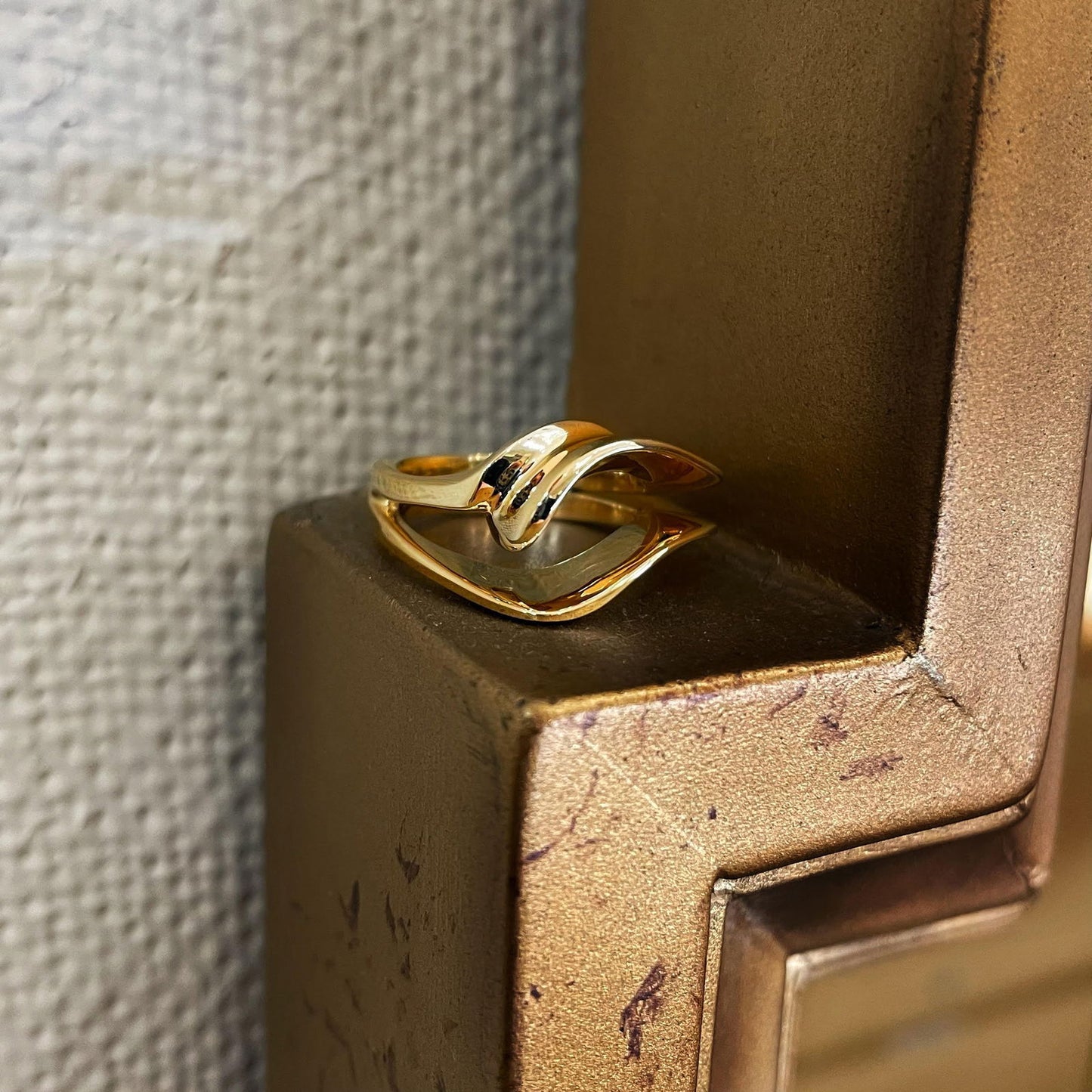 Photo of Plumb Gold Legacy Wave Ring in a decorative scene, designed by , available at Plumb Gold & Plumb Silver