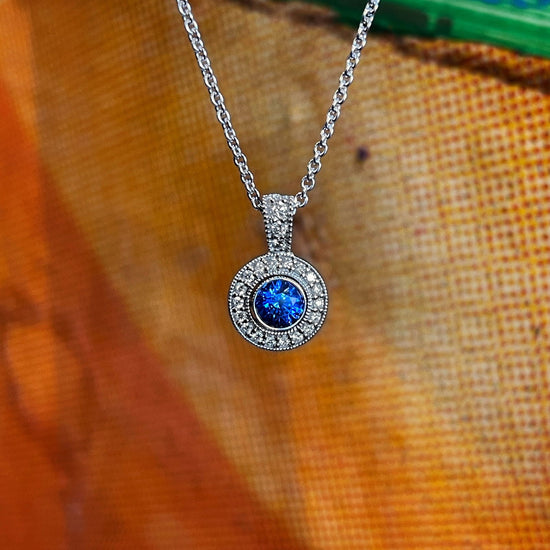 Photo of Plumb Gold Original Blue Sapphire and Diamond Pendant in a decorative scene, designed by , available at Plumb Gold & Plumb Silver