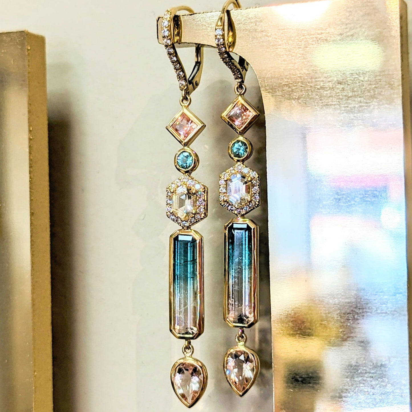 Photo of Plumb Gold Original Multi-Gem Dangle Earrings in a decorative scene, designed by , available at Plumb Gold & Plumb Silver