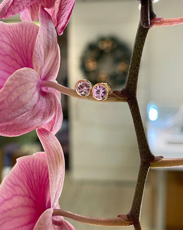 Photo of Plumb Gold Original Tunduru Spinel Studs in a decorative scene, designed by , available at Plumb Gold & Plumb Silver