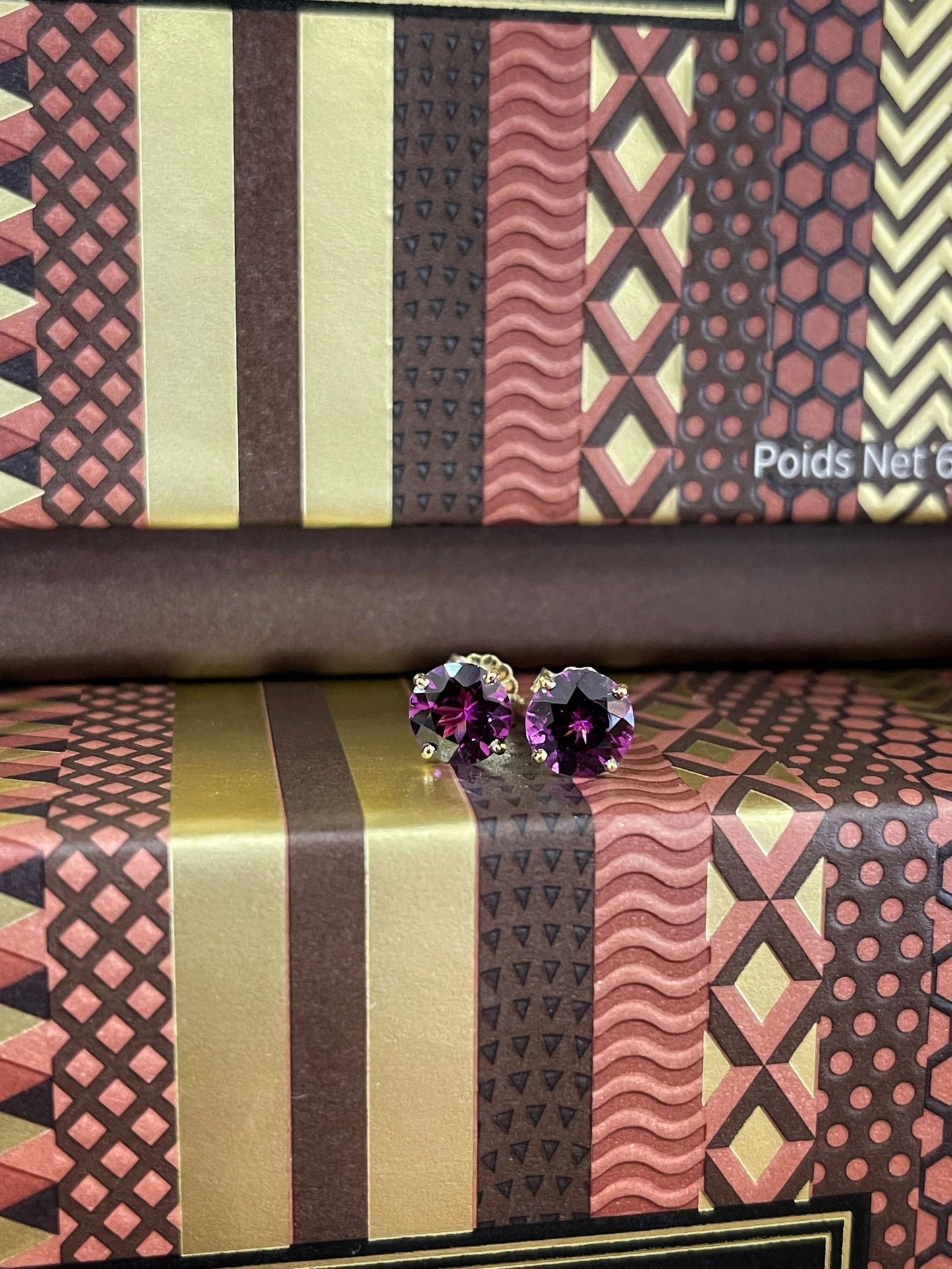 Photo of Purple Garnet Studs in a decorative scene, designed by , available at Plumb Gold & Plumb Silver