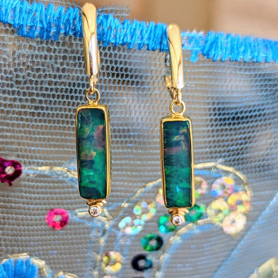 Photo of Rectangle Opal Dangles in a decorative scene, designed by , available at Plumb Gold & Plumb Silver