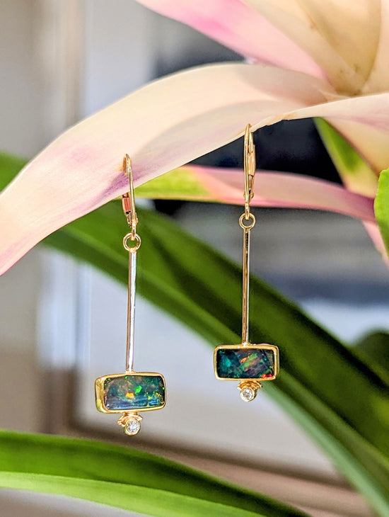 Photo of Rectangle Opal Drop Earrings in a decorative scene, designed by , available at Plumb Gold & Plumb Silver