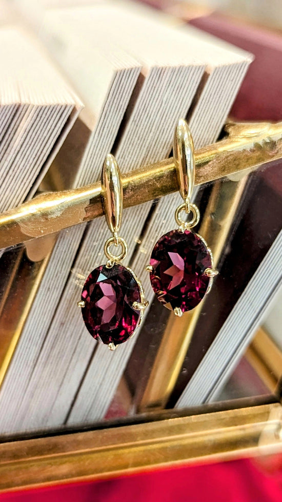 Photo of Rhodolite Dangles in a decorative scene, designed by , available at Plumb Gold & Plumb Silver