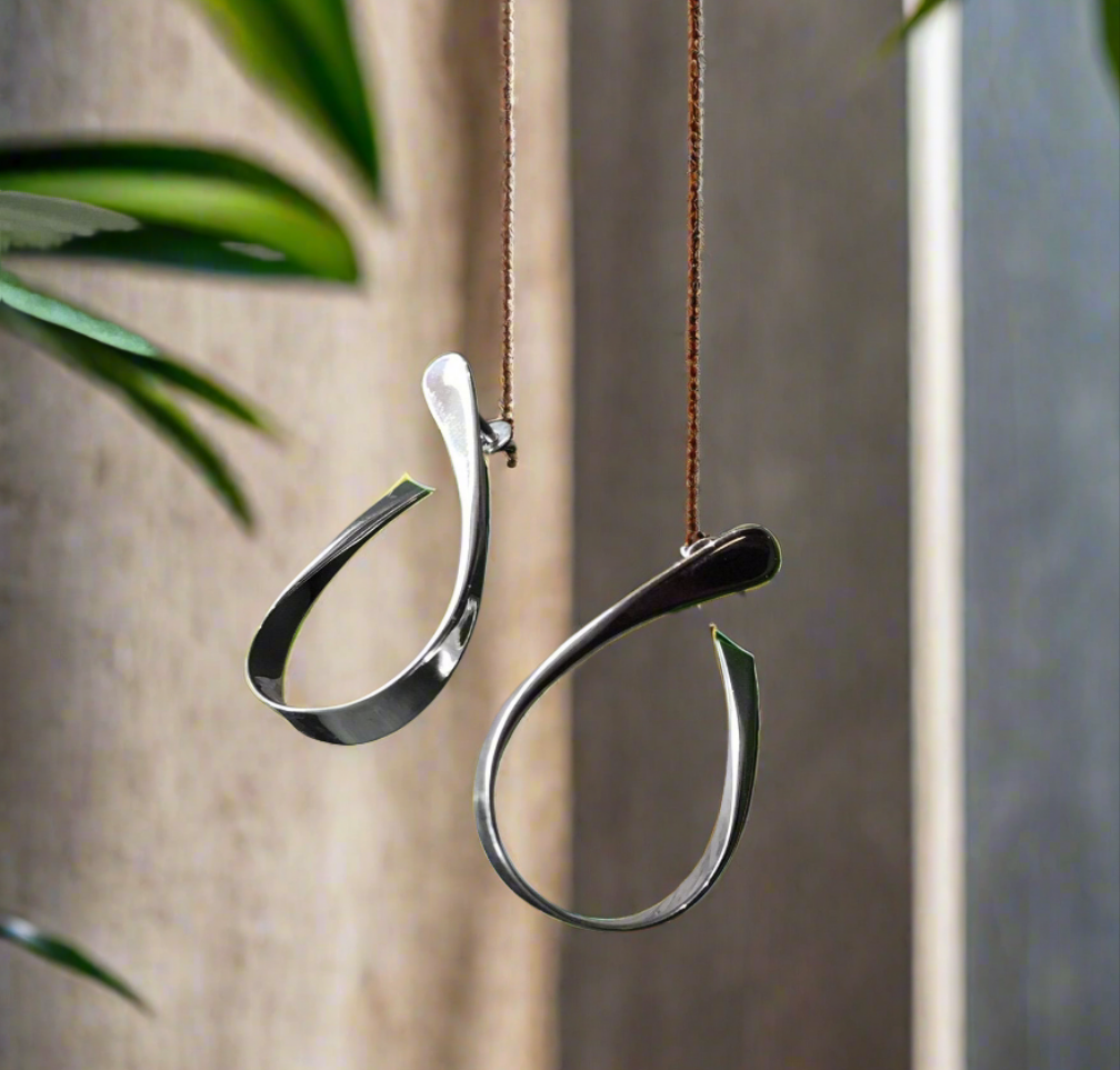 Photo of "Rhythmic Hoop" Earrings in a decorative scene, designed by , available at Plumb Gold & Plumb Silver
