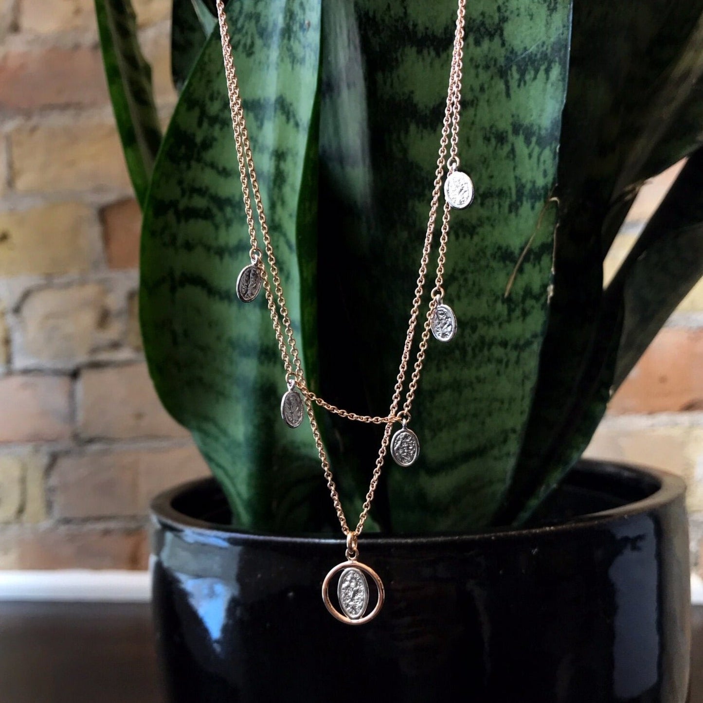 Photo of Rose Layered Necklace in a decorative scene, designed by , available at Plumb Gold & Plumb Silver