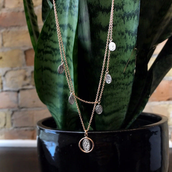 Photo of Rose Layered Necklace in a decorative scene, designed by , available at Plumb Gold & Plumb Silver