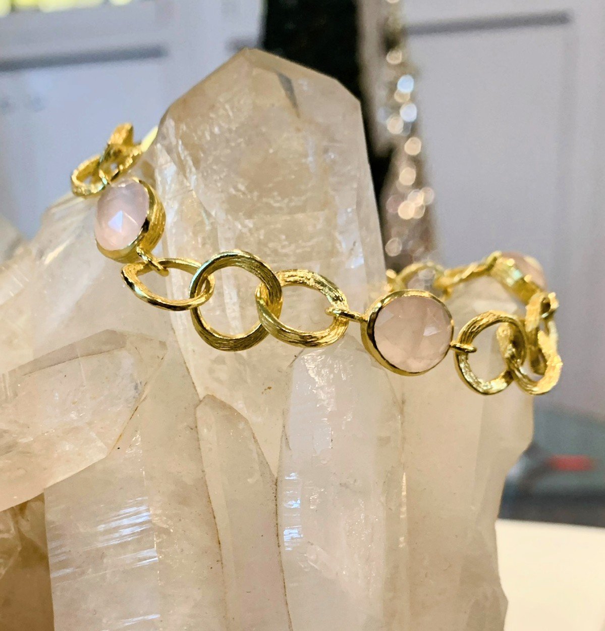 Photo of Rose Quartz and Gold Plated Link Bracelet in a decorative scene, designed by , available at Plumb Gold & Plumb Silver