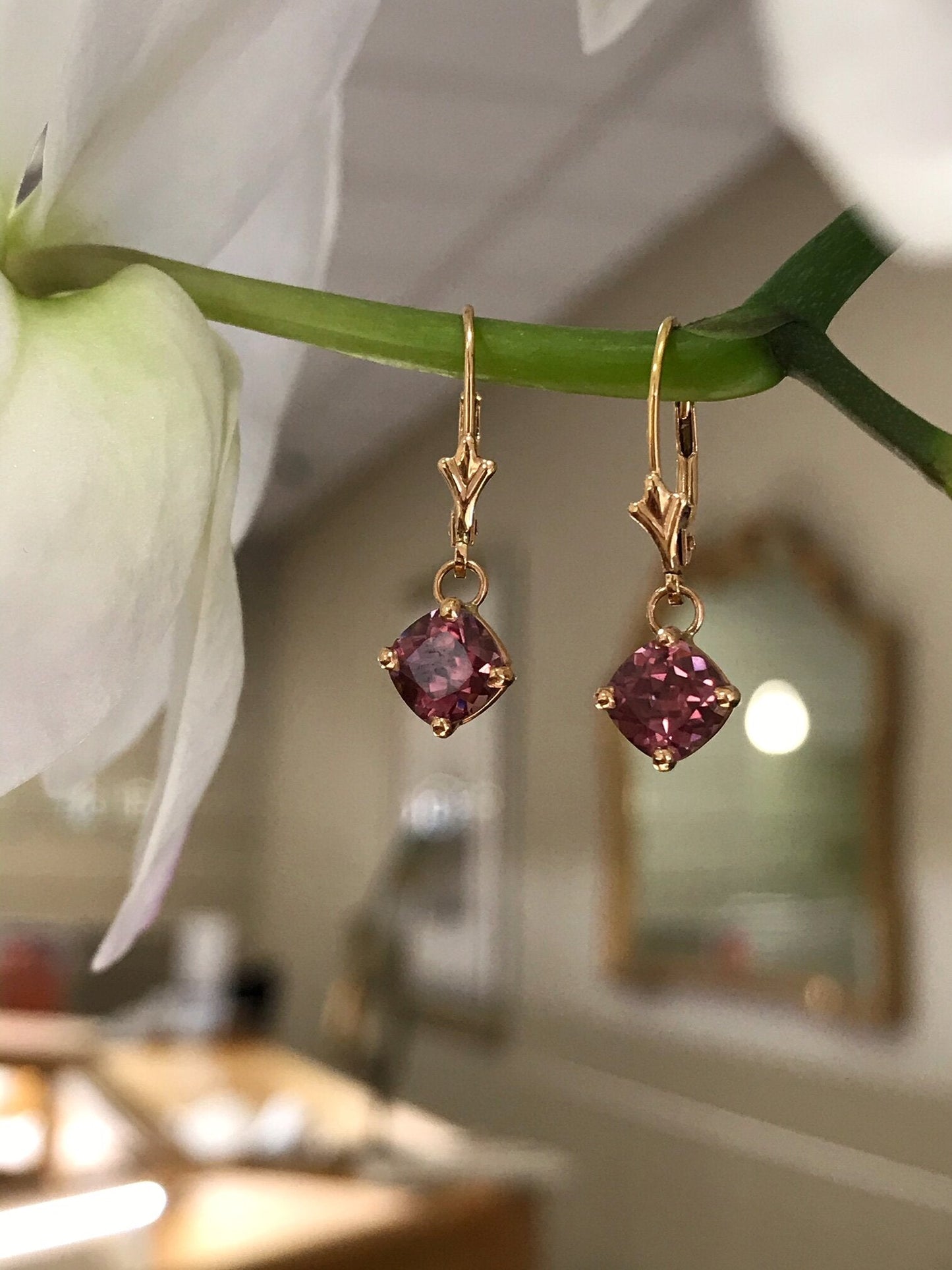 Photo of Rose Zircon Dangles in a decorative scene, designed by , available at Plumb Gold & Plumb Silver