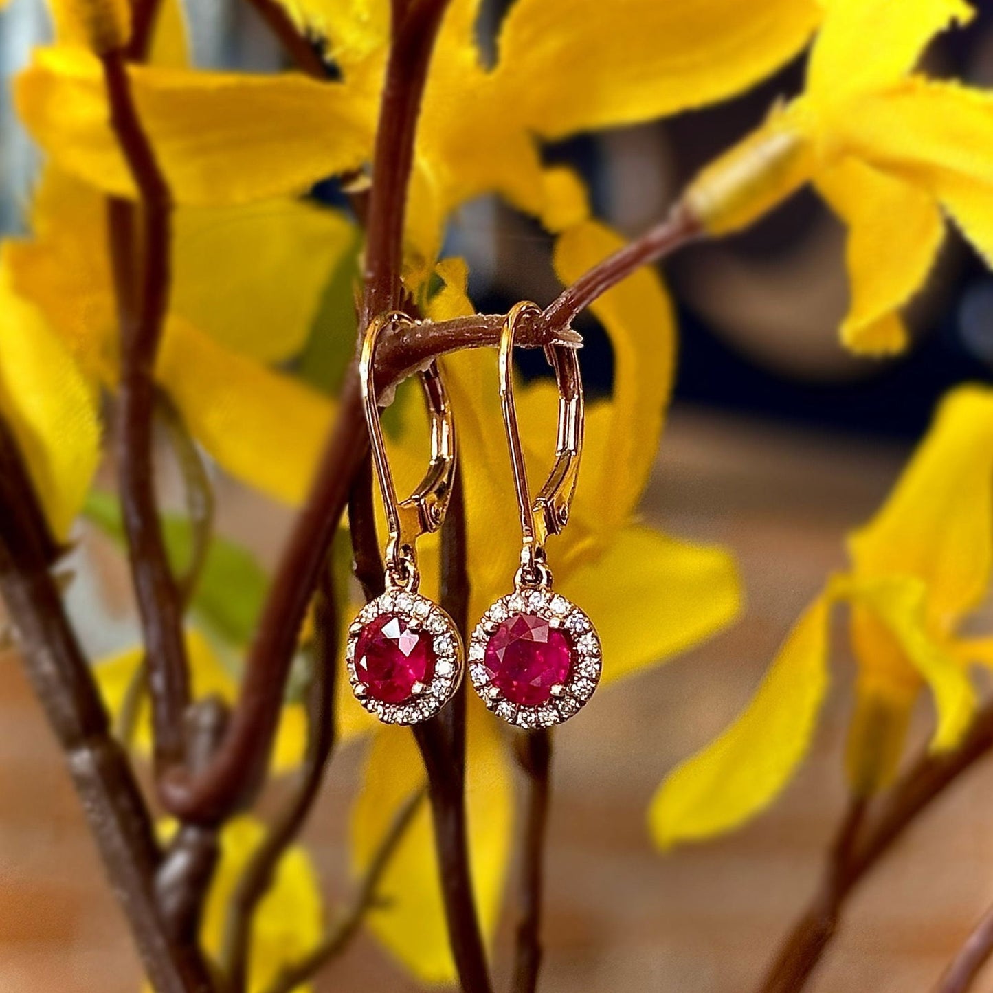 Photo of Rosy Ruby Halo Dangles in a decorative scene, designed by , available at Plumb Gold & Plumb Silver