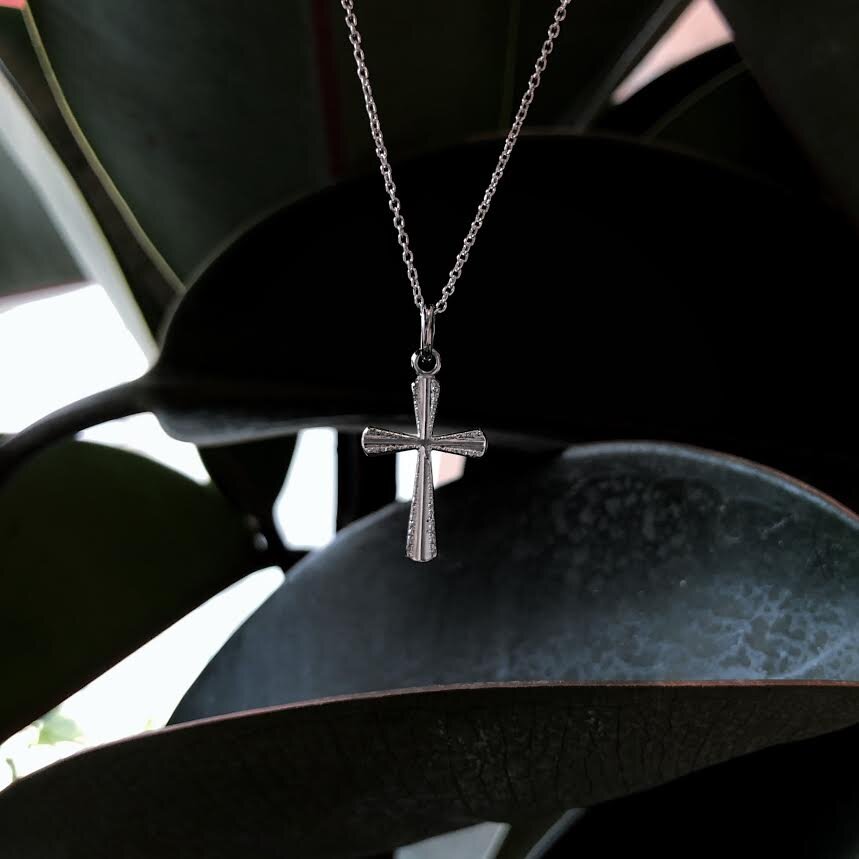 Photo of Rough Edge Cross in a decorative scene, designed by , available at Plumb Gold & Plumb Silver