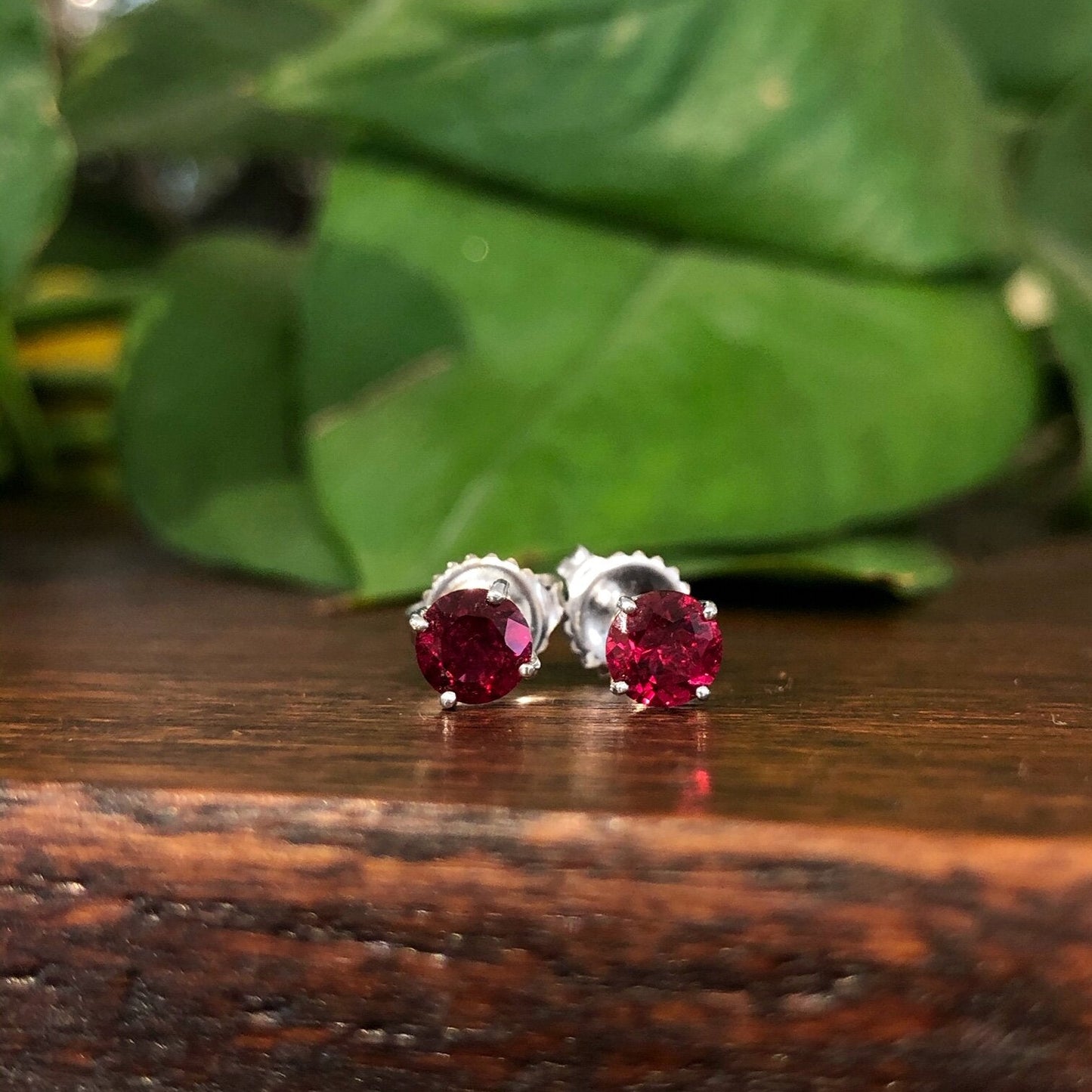 Photo of Rubelite Studs in a decorative scene, designed by , available at Plumb Gold & Plumb Silver