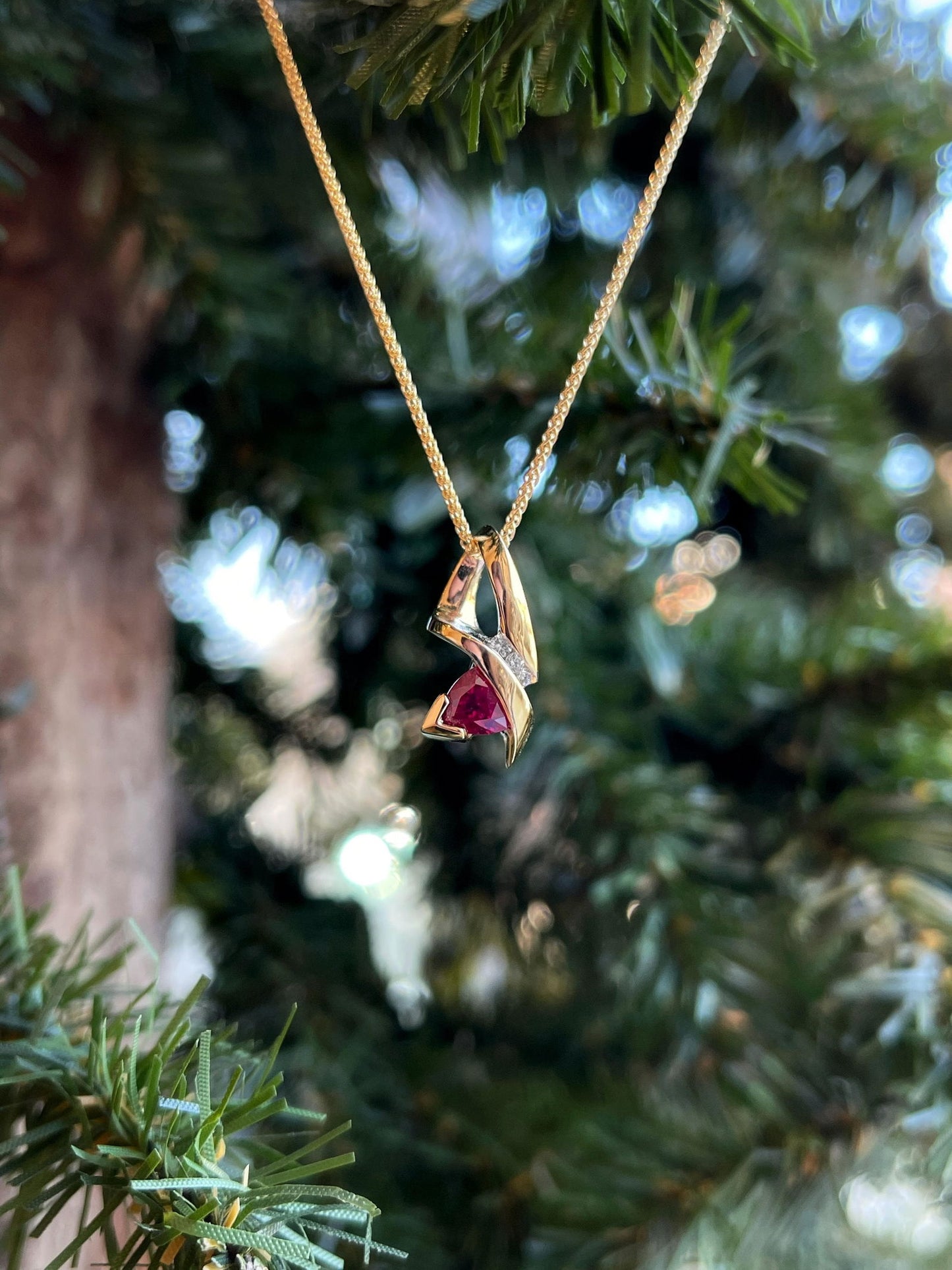 Photo of Ruby Pendant in a decorative scene, designed by , available at Plumb Gold & Plumb Silver