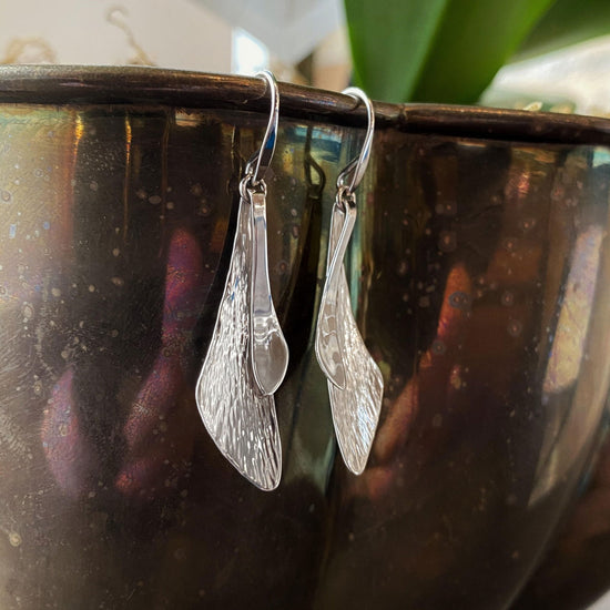 Photo of "Samara" Earrings in a decorative scene, designed by , available at Plumb Gold & Plumb Silver