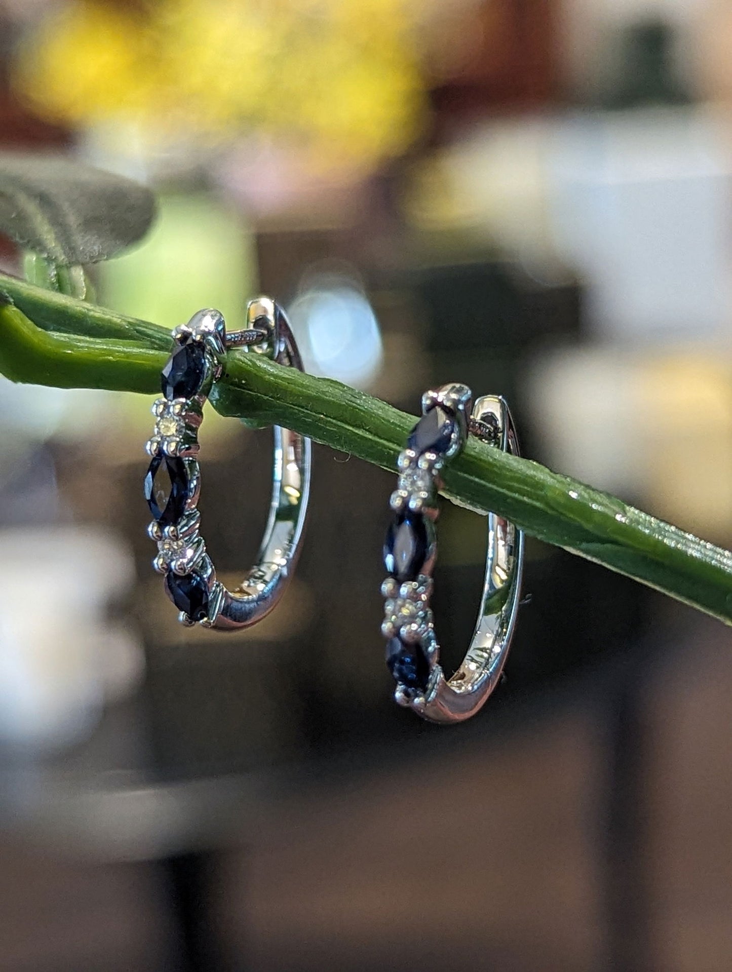 Photo of Sapphire & Diamond Hoops in a decorative scene, designed by , available at Plumb Gold & Plumb Silver