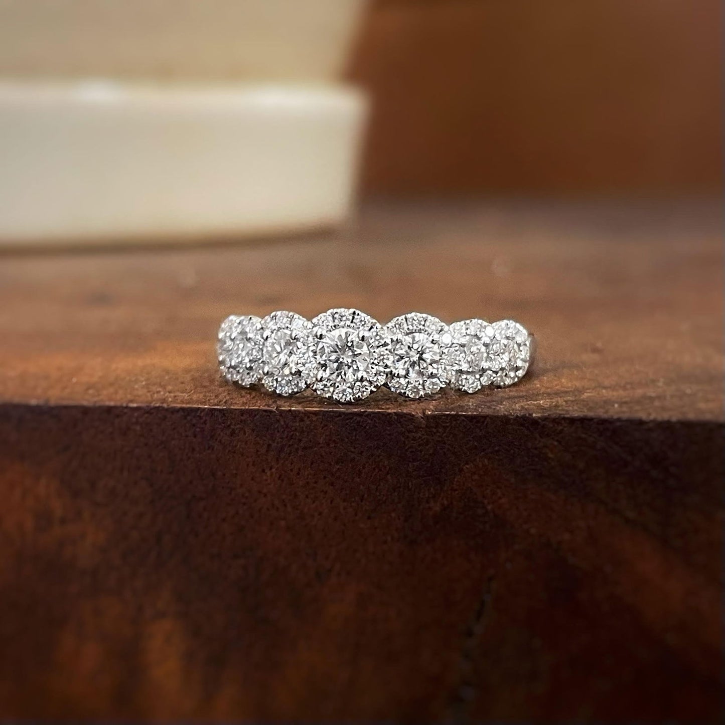 Photo of Seven Halos Diamond Anniversary Band in a decorative scene, designed by , available at Plumb Gold & Plumb Silver