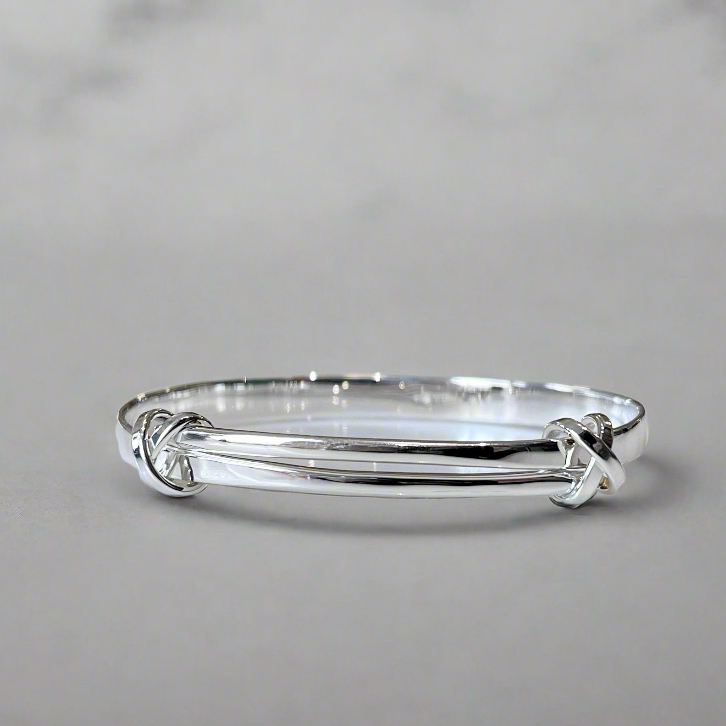 Photo of "Signature Kiss" Bracelet in a decorative scene, designed by , available at Plumb Gold & Plumb Silver