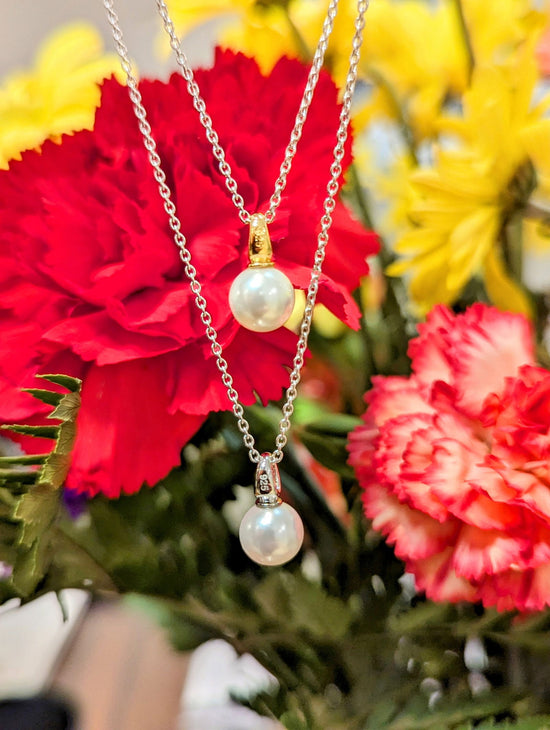 Photo of Single Pearl Necklace in a decorative scene, designed by , available at Plumb Gold & Plumb Silver