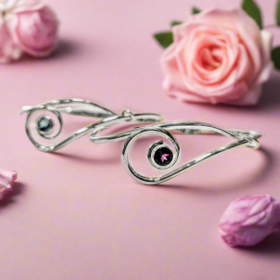 Photo of "Sliding Clef" Bracelet in a decorative scene, designed by , available at Plumb Gold & Plumb Silver