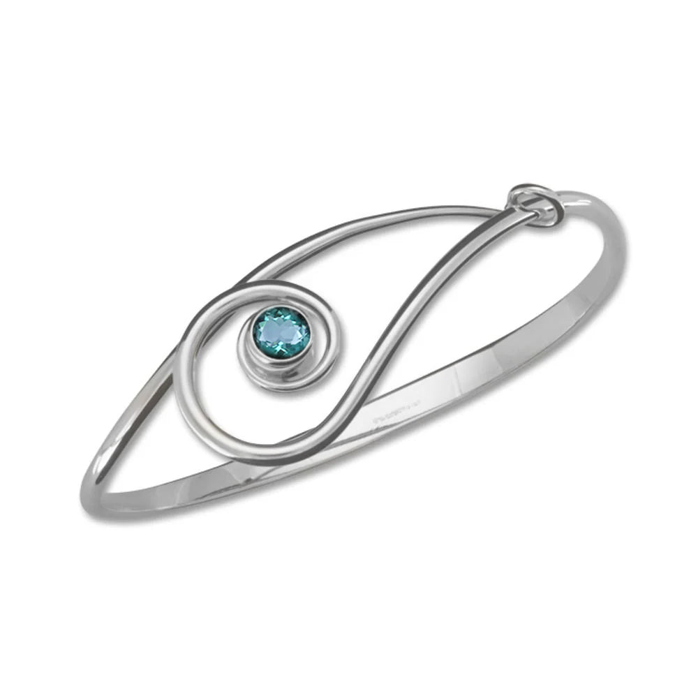 Photo of "Sliding Clef" Bracelet in a decorative scene, designed by , available at Plumb Gold & Plumb Silver